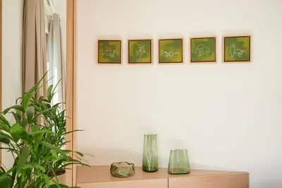 a shelf with two vases on a table with a plant at KaiZen Chania - New Central Apartment Just 350m Away With Private Jacuzzi and free parking! in Chania Town