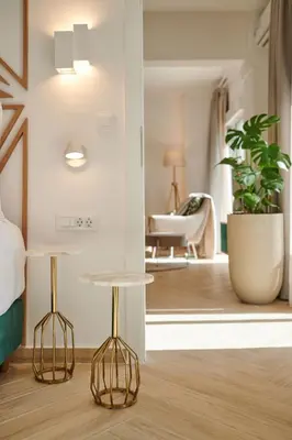 a bedroom with a bed and two tables in a room at KaiZen Chania - New Central Apartment Just 350m Away With Private Jacuzzi and free parking! in Chania Town
