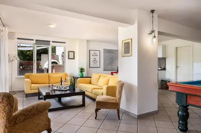 a living room with couches and a pool table at Eos Studio in Chania Town