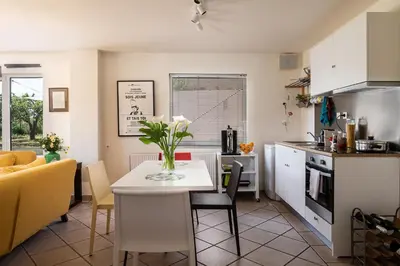 a kitchen with a table with a vase of flowers on it at Eos Studio in Chania Town