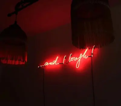 a neon sign that says well i love it in a room at Eos Studio in Chania Town