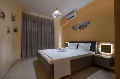 a bedroom with a large bed and a window at Eleni's apartment in the center of Chania in Chania Town