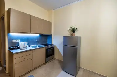 a small kitchen with a refrigerator and a sink at Eleni's apartment in the center of Chania in Chania Town