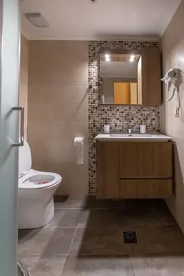 a bathroom with a sink and a toilet and a mirror at Eleni's apartment in the center of Chania in Chania Town