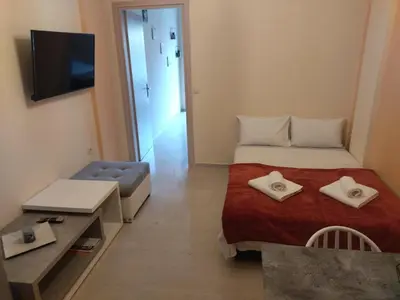 a small room with a bed and a tv at Eleni's apartment in the center of Chania in Chania Town