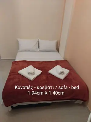 a bedroom with a bed with two towels on it at Eleni's apartment in the center of Chania in Chania Town