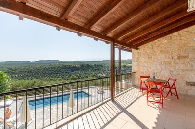a view from the balcony of a house with a table and chairs at Villa Daya in Darmarochori