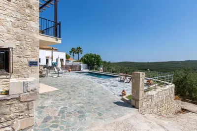 a villa with a swimming pool and a house at Villa Daya in Darmarochori