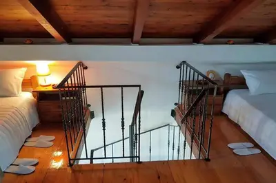 a room with two beds and a staircase in a room at 'Sky and Sea 1' Apartment in Kato Daratso