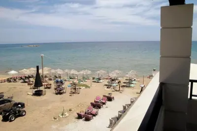 a view of a beach with chairs and umbrellas at 'Sky and Sea 1' Apartment in Kato Daratso