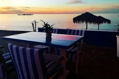 a table on the beach with a view of the ocean at 'Sky and Sea 1' Apartment in Kato Daratso