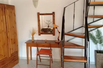 a room with a desk and a ladder and a mirror at 'Sky and Sea 1' Apartment in Kato Daratso
