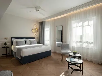 a bedroom with a bed and a living room at Riviera Suites in Chania Town