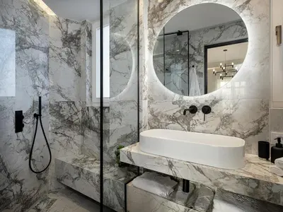 a bathroom with a sink and a mirror at Riviera Suites in Chania Town