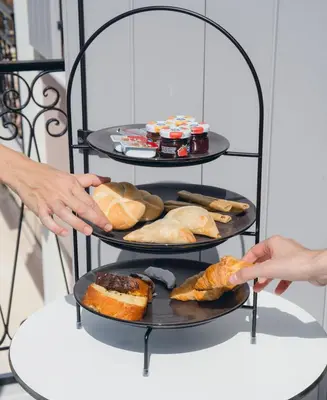 two people reaching for breads on a three tiered plate at Riviera Suites in Chania Town