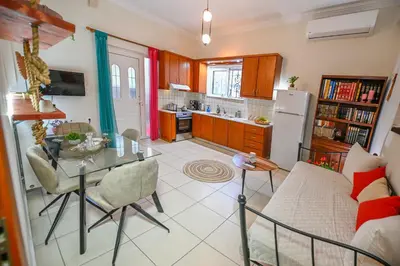 a kitchen and living room with a table and a couch at Popi's House in Chania Town
