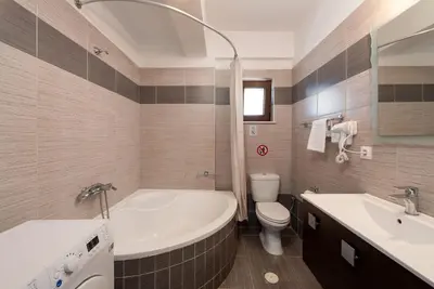 a bathroom with a tub and a toilet and a sink at Villa Stratianna by PosarelliVillas in Módhion