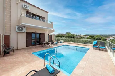 a villa with a swimming pool and a balcony at Villa Stratianna by PosarelliVillas in Módhion