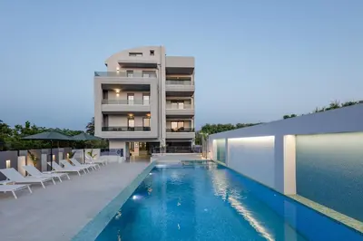a building with a swimming pool in front of a building at Aurora apartments in Chania Town