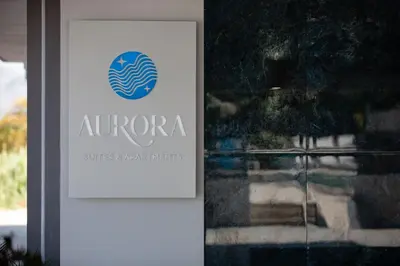 a sign for a su entrance to a building at Aurora apartments in Chania Town