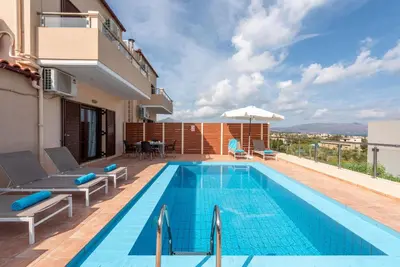 a swimming pool on the roof of a house at Villa Flora by PosarelliVillas in Módhion