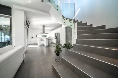 a hallway of a house with stairs and a table at La Maison Du Soleil Luxury Villa by 8essentially in Varípetron