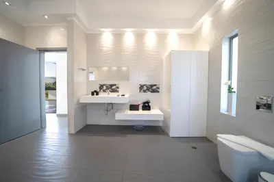 a white bathroom with two sinks and a toilet at La Maison Du Soleil Luxury Villa by 8essentially in Varípetron