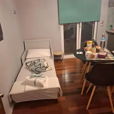 a small room with a bed and a table at Art and view-studio in Kounoupidhianá