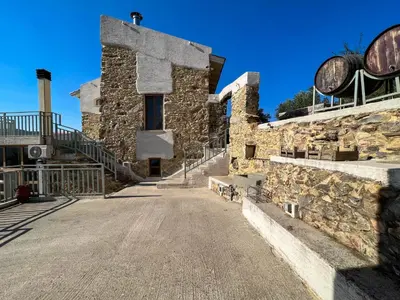 a stone building with stairs and a street at The Stone House - Two Bedrooms Maisonette in Avdhoulianá