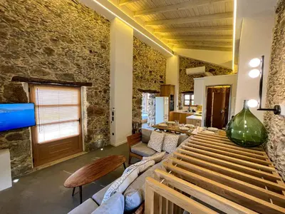 a living room with a couch and a table at The Stone House - Two Bedrooms Maisonette in Avdhoulianá