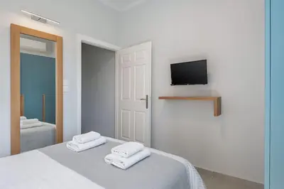 a bedroom with a bed with towels on it at West City Suite in Chania Town
