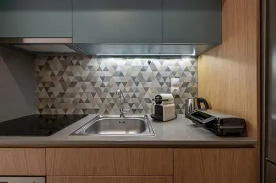 a kitchen counter with a sink and a toaster at West City Suite in Chania Town
