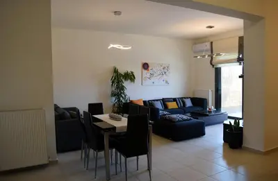 a living room with a couch and a table at Zoe's Luxury Home - Private Parking in Chania Town