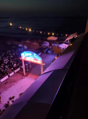 a stage with a sign on it at night at Sky & Sea 2 in Kato Daratso