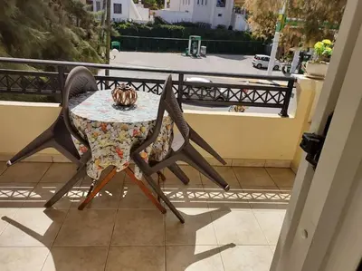a table and chairs sitting on a balcony at Sky & Sea 2 in Kato Daratso