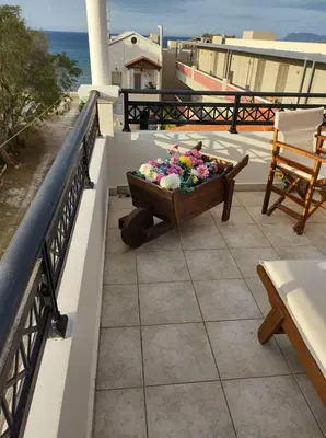 a pot of flowers sitting on a balcony at Sky & Sea 2 in Kato Daratso