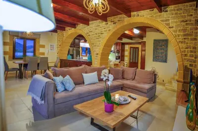 a living room with a couch and a table at Villa Drapanias Homeleader in Drapaniás