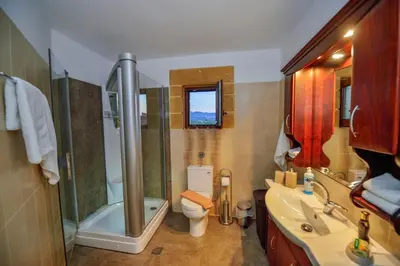 a bathroom with a shower and a toilet and a sink at Villa Drapanias Homeleader in Drapaniás