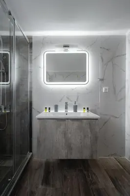 a bathroom with a sink and a glass shower at OLIVE ANGEL in Chania Town