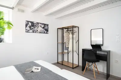 a bedroom with a bed and a desk and a mirror at OLIVE ANGEL in Chania Town