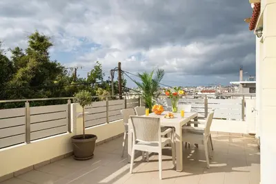 a white table and chairs on a balcony at OLIVE ANGEL in Chania Town