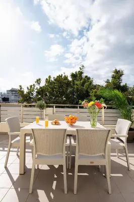 a white table and chairs on a patio at OLIVE ANGEL in Chania Town