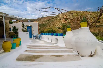 a group of large white vases sitting on a sidewalk at Trigono Traditional House in Kalivianí