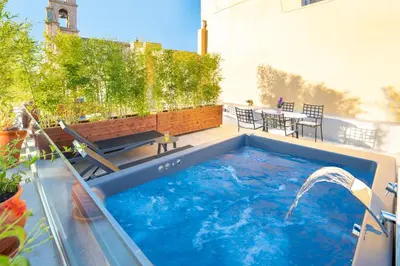 a hot tub on a patio with a table at Vener Suites in Chania Town