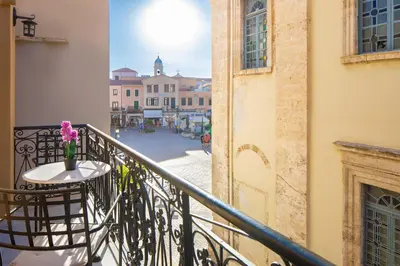 a balcony with a table and a view of a street at Vener Suites in Chania Town