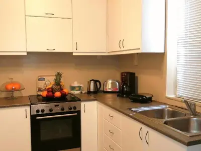 a kitchen with a sink and a stove top oven at Odyseia Apts ΙI at the Center of the City & Old Town in Chania Town