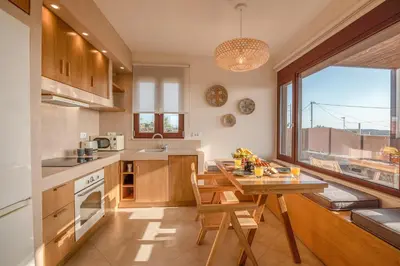 a kitchen with a wooden table and a dining room at Sia Elafonisi Pool House in Elafonisi