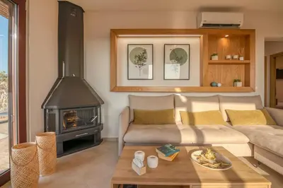 a living room with a couch and a fireplace at Sia Elafonisi Pool House in Elafonisi