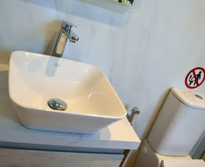 a bathroom with a sink and a toilet at Cozy Val in Chania Town