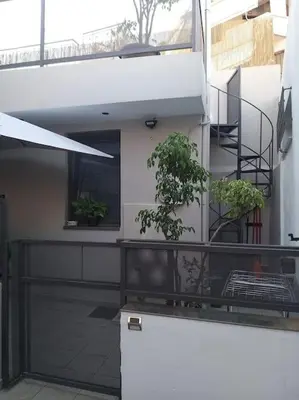a building with a balcony with potted plants on it at Cozy Val in Chania Town